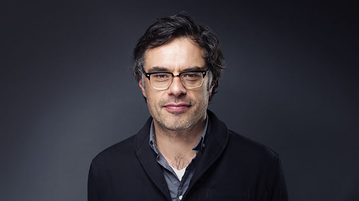 Jemaine Clement in a black jacket.